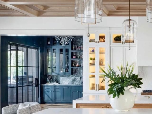 Kitchen with white oak coffered ceiling and marble island