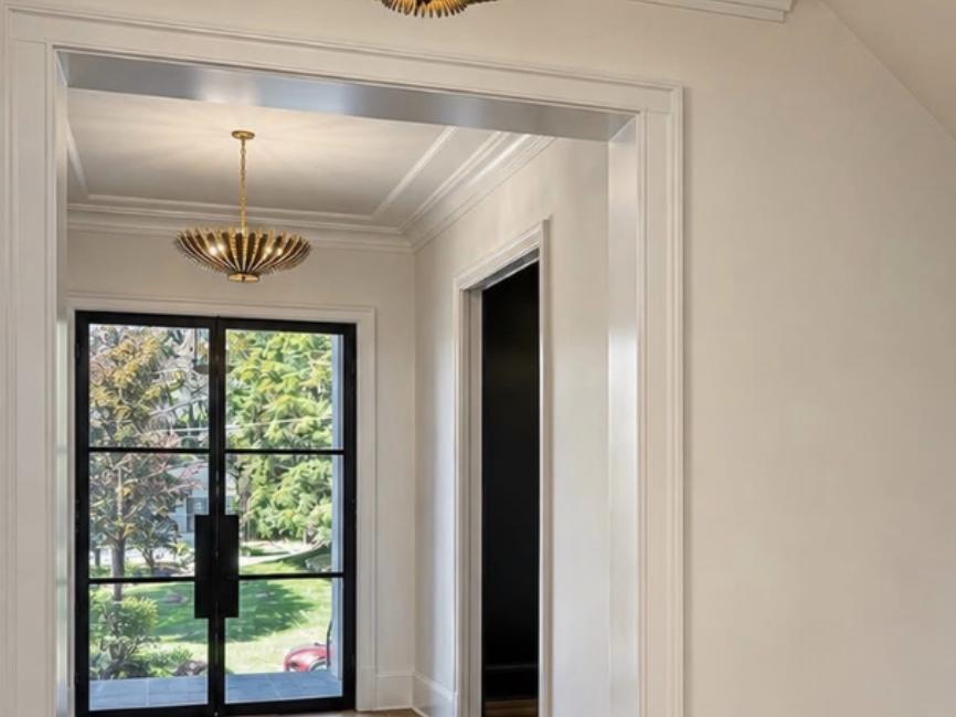 Entry hall with steel-framed glass front door and brass ceiling fixture