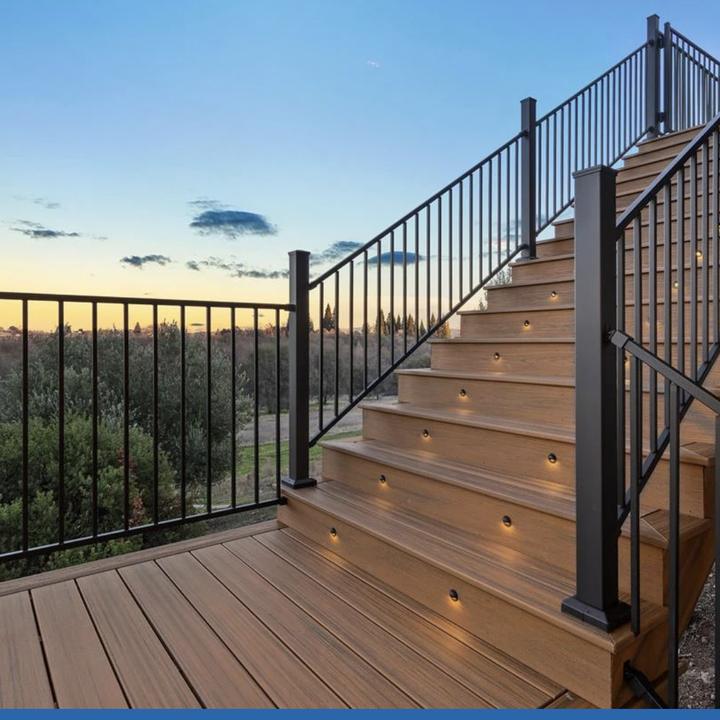 Composite deck stair with black steel railing and riser lighting